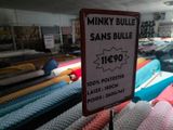 a sign that is in front of many different types of blankets