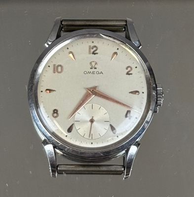 a silver watch with a white face and numbers on it
