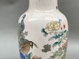 a white vase with a red and blue design on it
