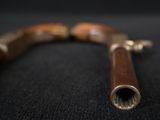 a close up of a wooden handle on a black surface