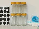 four bottles and a bag on a table