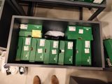 a drawer full of green boxes and a pair of brown shoes