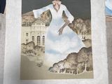 a painting of a woman in a white dress on a table