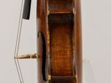 a violin that is sitting on a stand on a table
