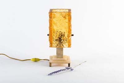 a small lamp that is sitting on a wooden stand