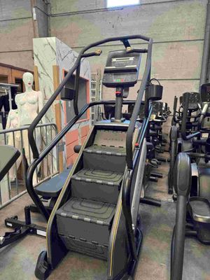 a picture of a gym room with treads and machines