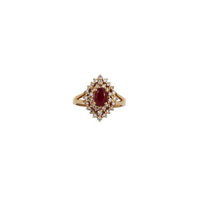 a gold ring with a red stone surrounded by white diamonds