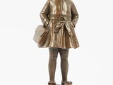 bronze figurine of a girl with a hat and a bag