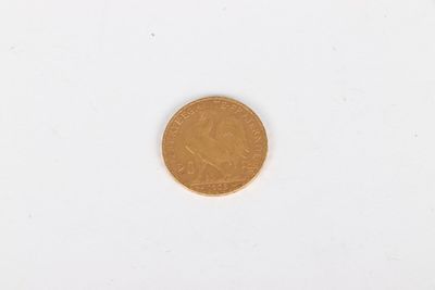 a close up of a coin on a white surface