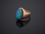 a gold ring with an oplite stone in the center