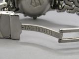a close up of a wrist watch with a tag on it
