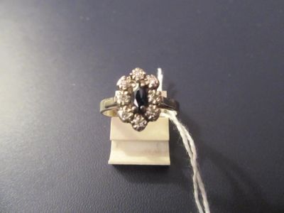 an image of a ring with a blue stone surrounded by white diamonds