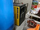 a blue tank sitting next to a yellow container in a room
