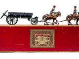 three figurines of horses pulling a carriage and a man on a horse drawn carriage