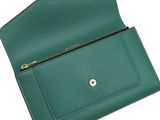 a close up of a green purse on a white background