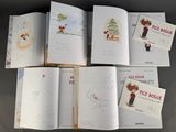 several children ' s books with drawings and pictures on them on a table