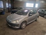 a silver car parked in a garage with other cars