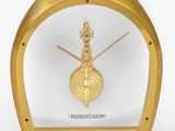 a gold clock with a clock face on it