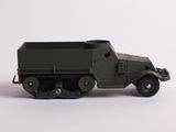 a toy army truck that is on a white surface