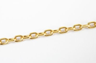 a close up of a gold chain on a white background