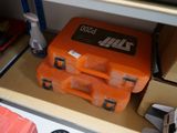 two orange cases sitting on top of a shelf