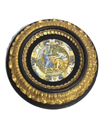 an image of a decorative plate with a picture of a man and woman on it