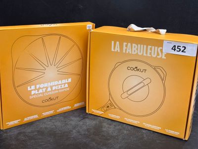 two boxes of food sitting on top of a table next to each other