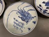 three blue and white plates sitting on a table