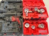 deux coffres à outils rouges contenant des outils, posés sur une table
