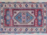 a close up of a colorful rug on a tiled floor