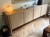 a picture of a living room with wood floors and a large painting on the wall