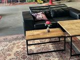 an image of a living room with couches and coffee tables