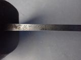 a silver spoon with writing on it sitting on a table