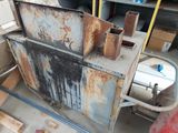a rusted metal cabinet in the middle of a garage