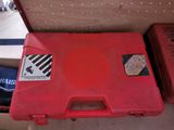 a red tool box sitting on top of a table
