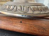 a close up of a lamp on a wooden table