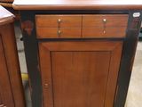 a wooden cabinet with two drawers on top of it