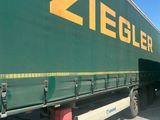 a green semi truck with a yellow ziegler logo on the side of it