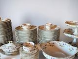 a lot of plates and bowls sitting on a table