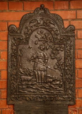 a plaque on the side of a brick wall with a picture of a man and a dog