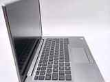 a silver laptop with a black keyboard on a white surface