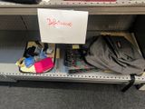 a sign on a shelf in a store with a lot of items on it