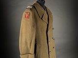 an army coat with a red v patch on the chest
