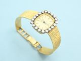 an 18k yellow gold ladies ' s wrist watch with diamonds