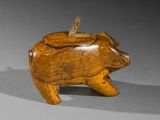 an image of a wooden pig figurine on a gray surface