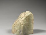 an image of a carved rock sitting on top of a white surface