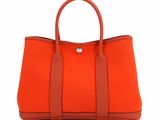 a small orange handbag on a white background