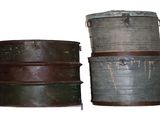 two old metal containers sitting side by side on a white surface