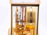 a gold clock that is sitting on top of a table