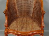 an image of a wooden chair with a wicker seat on it